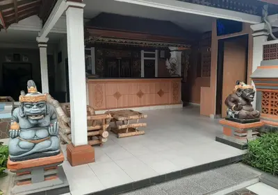 a group of statues on the front of a house at Dewa Bharata Bungalows Legian in Legian