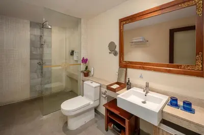 a bathroom with a toilet and a sink and a shower at Rama Residence Seminyak in Seminyak