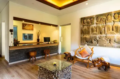 a living room with a large painting on the wall at Lasanti Villas Seminyak in Seminyak