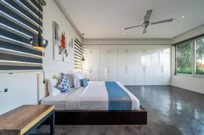 a bedroom with a bed and a table at Villa Onyx in Seminyak