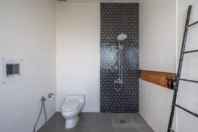a bathroom with a toilet and a shower at Villa Onyx in Seminyak