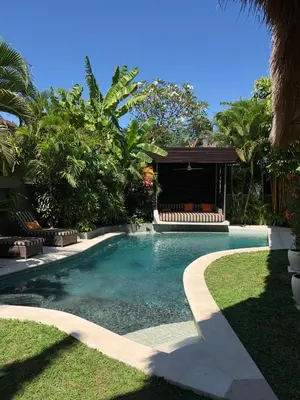 a swimming pool with a bench in a yard at Esha Villa Umalas 2 in Kerobokan