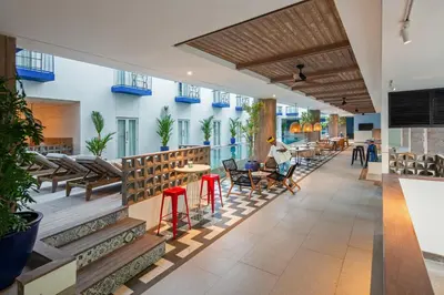 a lobby of a hotel with tables and chairs at Kampi Hotel Legian in Legian