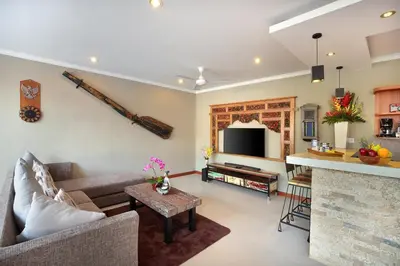 a living room with a couch and a table at Kae Villa Anggrek in Seminyak