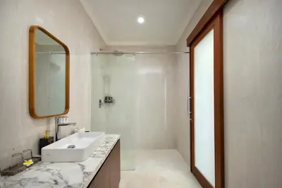 a bathroom with a sink and a mirror and a shower at Daha Mansions Seminyak in Seminyak