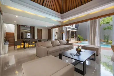 a living room with a couch and a table at Entrada Seminyak Villa By Nagisa Bali in Seminyak