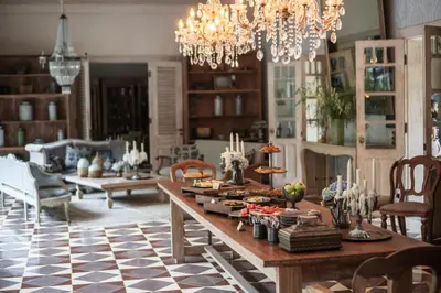 a living room with a table with food on it at Balquisse Heritage Hotel in Jimbaran