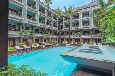 an exterior view of a hotel with a large swimming pool at The Vira Bali Boutique Hotel & Suite in Kuta