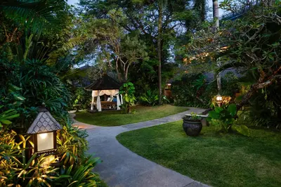 a garden with a pathway leading to a gazebo at Rama Beach Resort and Villas in Kuta
