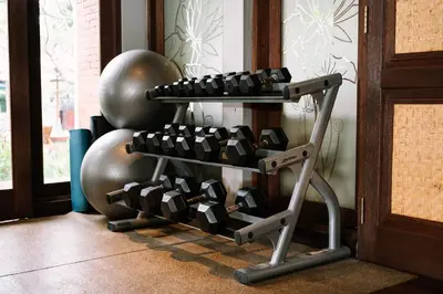 a rack of dumbbells in front of a exercise ball at Rama Beach Resort and Villas in Kuta