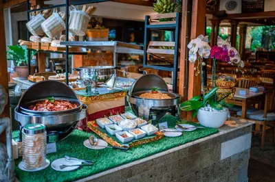 a buffet of food on top of a table at Rama Garden Hotel Bali in Legian