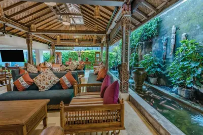 a living room with a couch and a fish tank mural at Rama Garden Hotel Bali in Legian
