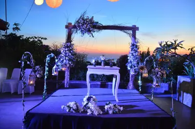 an outdoor ceremony with a white table and flowers at Champlung Mas Hotel Legian in Legian