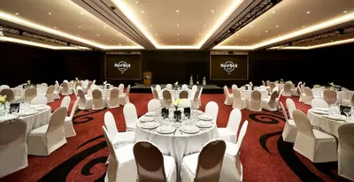 a banquet hall with white tables and white chairs at Hard Rock Hotel Bali in Kuta