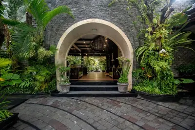 an entrance to a building with a bunch of plants at The Bali Dream Villa Seminyak in Seminyak