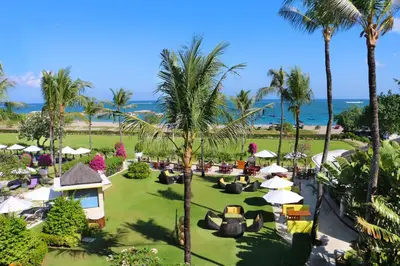 an aerial view of a resort with palm trees and the ocean at Holiday Inn Resort Baruna Bali by IHG in Kuta