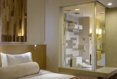 a bathroom with a glass shower and a sink at Holiday Inn Resort Baruna Bali by IHG in Kuta