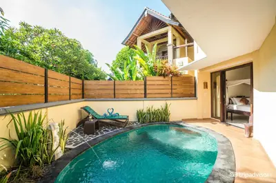 a swimming pool in the backyard of a house at Bali Ayu Hotel & Villas in Seminyak