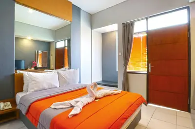 a bedroom with a bed with towels on it at Sayang Residence 2 in Denpasar