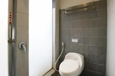 a bathroom with a toilet in a stall at Sayang Residence 2 in Denpasar