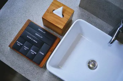 a wooden box next to a white sink at Uma Sapna Seminyak in Seminyak