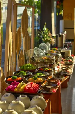 a buffet line with many plates of food on at Royal Hotel and Villa Bali in Legian