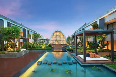 a resort with a swimming pool and a building at Aryaduta Bali in Kuta
