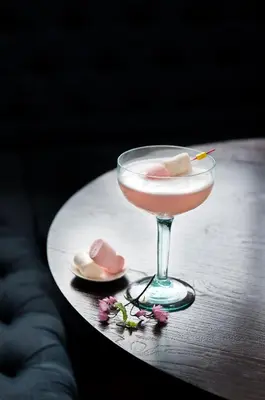 a drink sitting on a table with two slippers at Aryaduta Bali in Kuta