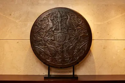 a wooden shield hanging on a wall at Aryaduta Bali in Kuta