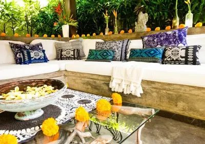 a living room with a couch and pillows and a table at Villa Besok in Seminyak