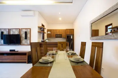 a dining room with a table with glasses on it at Villa Manis La Bora in Seminyak in Seminyak