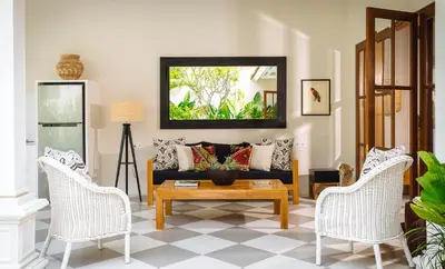 a living room with a couch and two chairs at Puri Pani in Seminyak