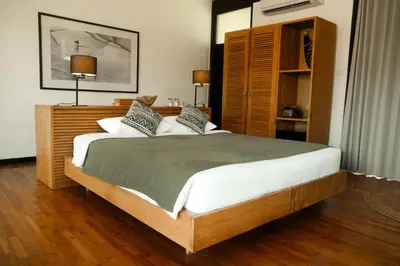a bedroom with a large bed in a room at Wave House Resort Canggu in Canggu