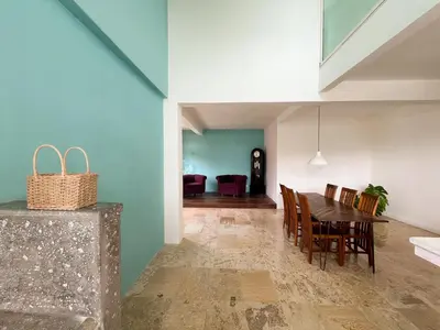 a dining room with a table and chairs at Kresna By The Sea By Kresna Hospitality in Seminyak