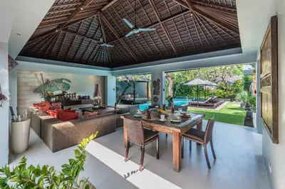a living room with a table and a couch at Kembali Villas in Seminyak