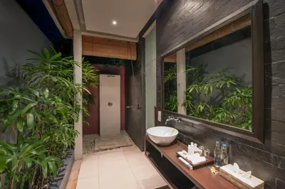 a bathroom with a sink and a mirror at Kembali Villas in Seminyak