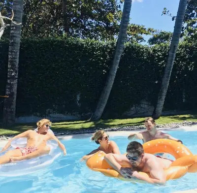 a group of people in a swimming pool at Kembali Villas in Seminyak