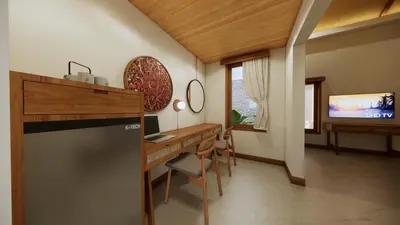 a kitchen with a desk and a television in a room at Tonys Villas & Resort Seminyak - Bali in Seminyak