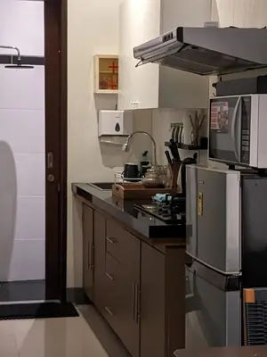 a kitchen with a stove and a refrigerator at Dim House Jimbaran in Jimbaran