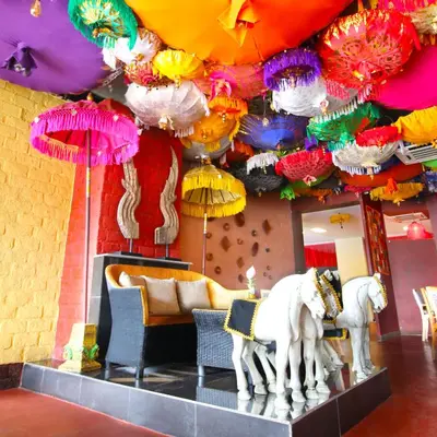a room with two statues of horses under umbrellas at Kupu Kupu Jimbaran Beach Hotel & Spa by L’Occitane in Jimbaran