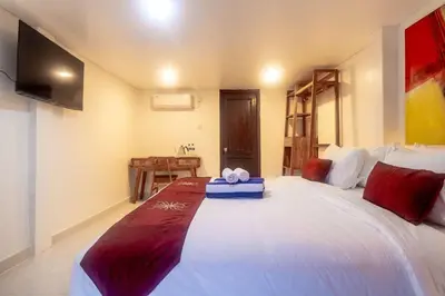a bedroom with a bed with a blue box on it at Degung de brata Family villas in Legian