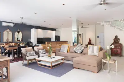 a living room with a couch and a table at Villa Bebek in Seminyak