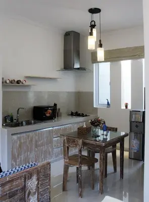 a kitchen with a table and a sink and a counter at Green Studio Apartment Seminyak in Seminyak