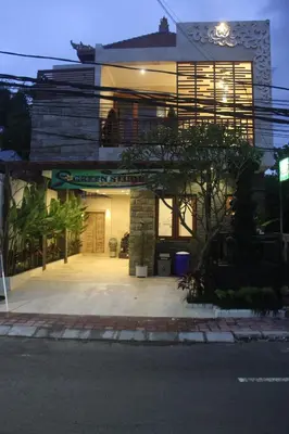 a large house with a large driveway in front of it at Green Studio Apartment Seminyak in Seminyak
