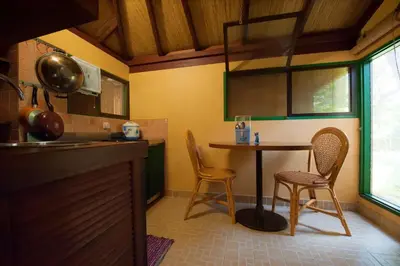 a kitchen with a small table and two chairs at Pondok Agung Bed & Breakfast in Nusa Dua