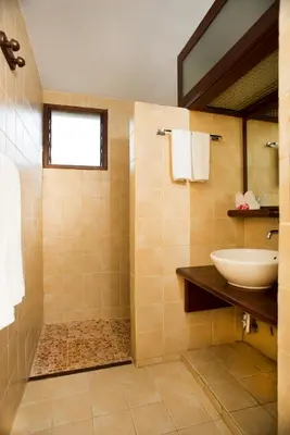 a bathroom with a sink and a shower at Pondok Agung Bed & Breakfast in Nusa Dua