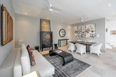 a living room with a white couch and a table at The Town House in Seminyak