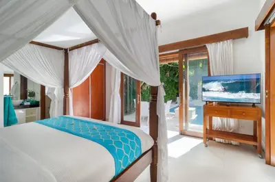 a bedroom with a bed and a flat screen tv at Super Value 3 Bed, Central Seminyak, Walk to Beach in Seminyak