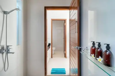 a bathroom with a mirror and a shower at Super Value 3 Bed, Central Seminyak, Walk to Beach in Seminyak