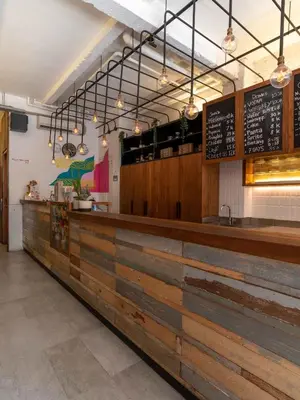 a fast food restaurant with a wooden counter top at M Boutique Hostel Legian in Legian